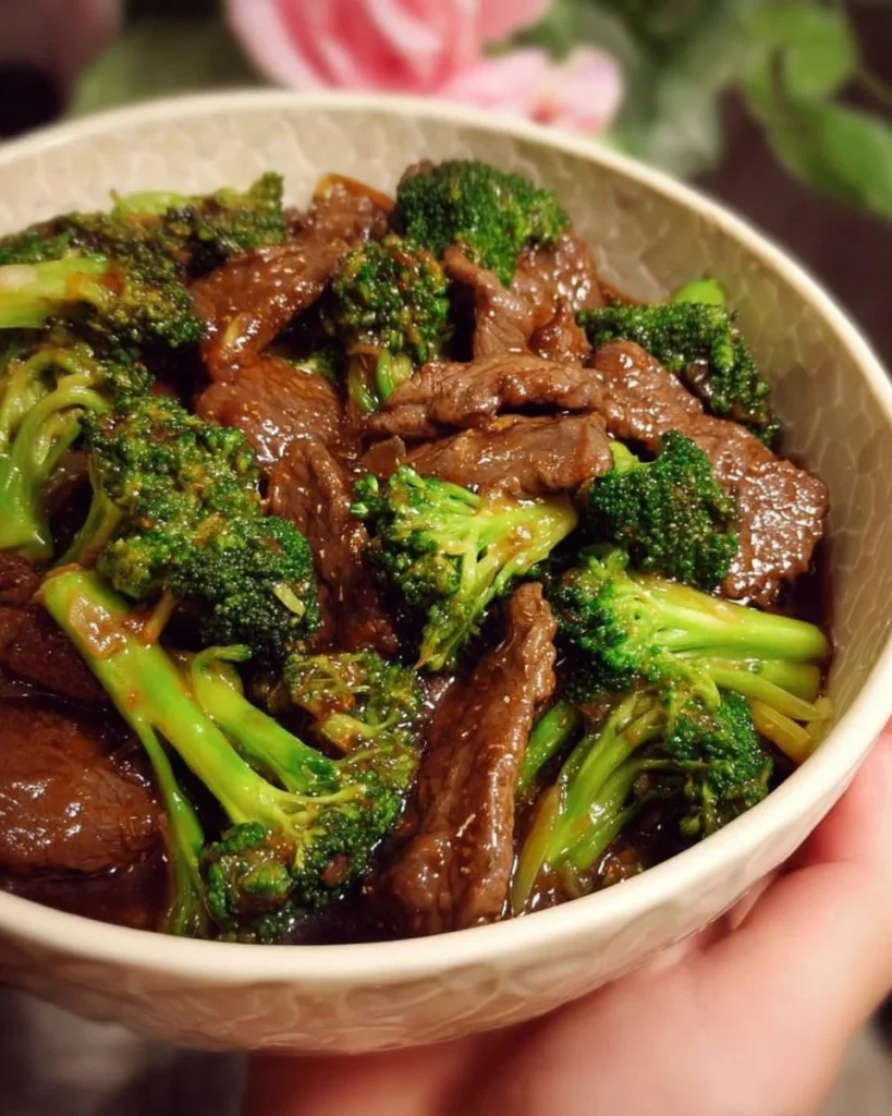 Beef and broccoli stir-fry served in a bowl with vegetables