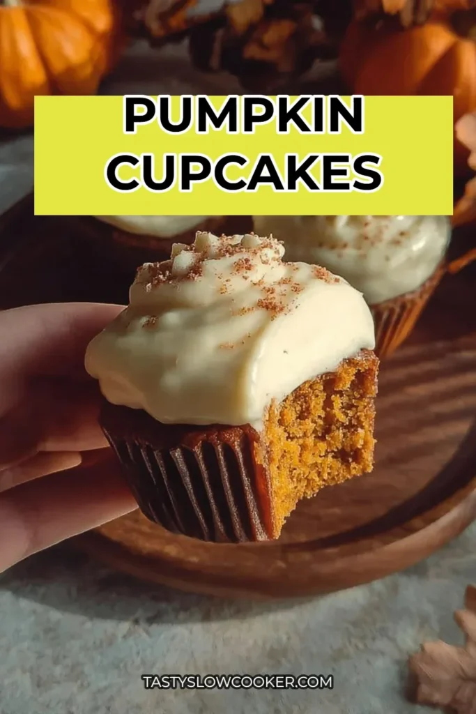 Freshly baked pumpkin cupcakes topped with cream cheese frosting.