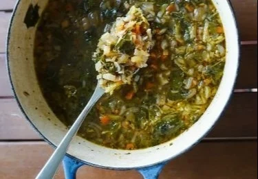 Bowl of Sardinia Herb Soup with fresh herbs and vegetables