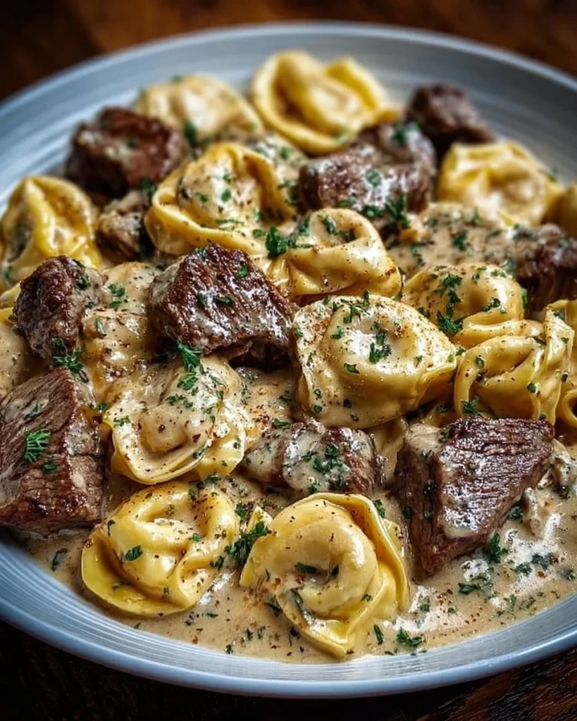 Delicious Cracked Garlic Steak Tortellini in creamy sauce served in a bowl