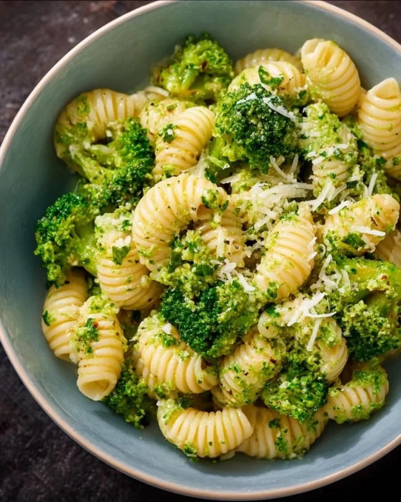 Plate of easy healthy broccoli pasta topped with parmesan cheese.