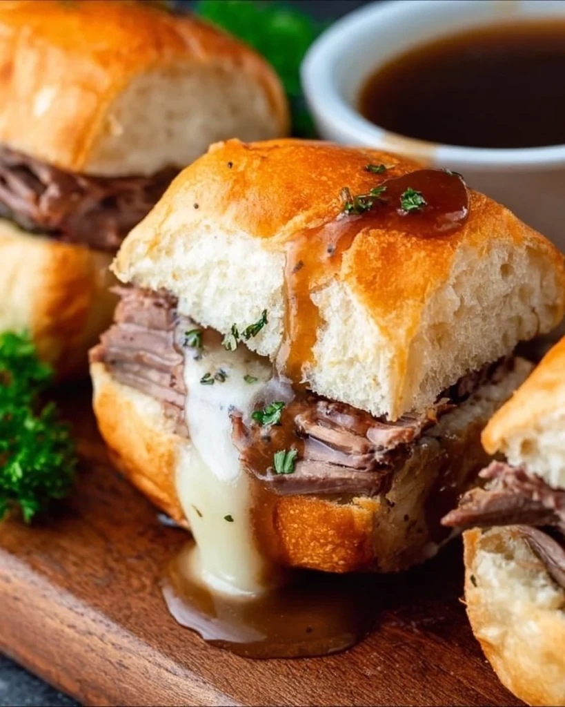 Delicious French Dip Sliders served with au jus for dipping