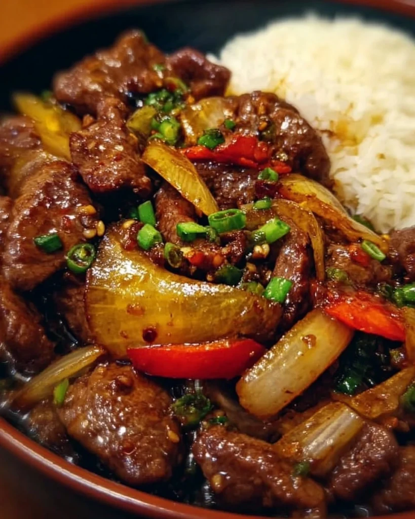 Sizzling Chinese pepper steak with onions served in a stir-fry dish