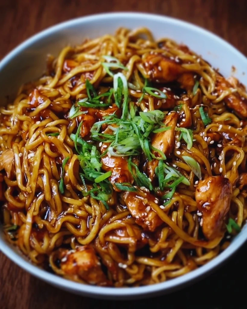 Delicious sticky garlic chicken noodles served in a bowl