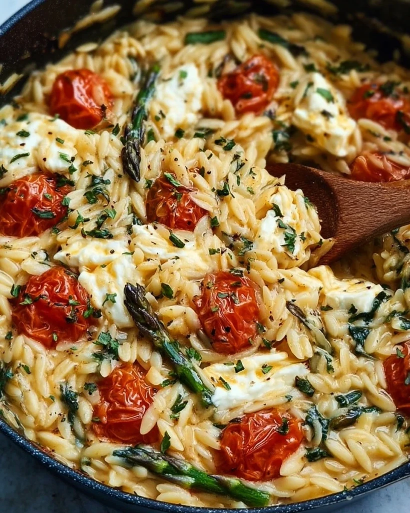 A delicious serving of baked feta orzo with colorful vegetables and herbs