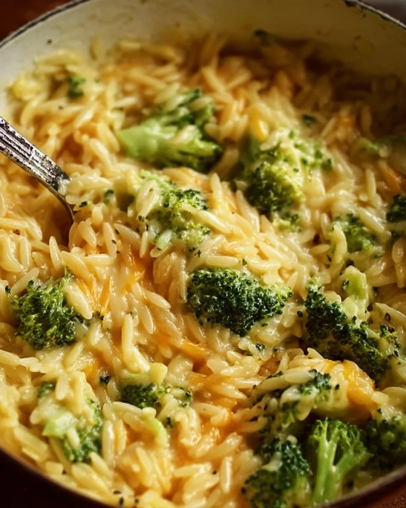 Creamy one-pot broccoli cheddar orzo dish served in a bowl