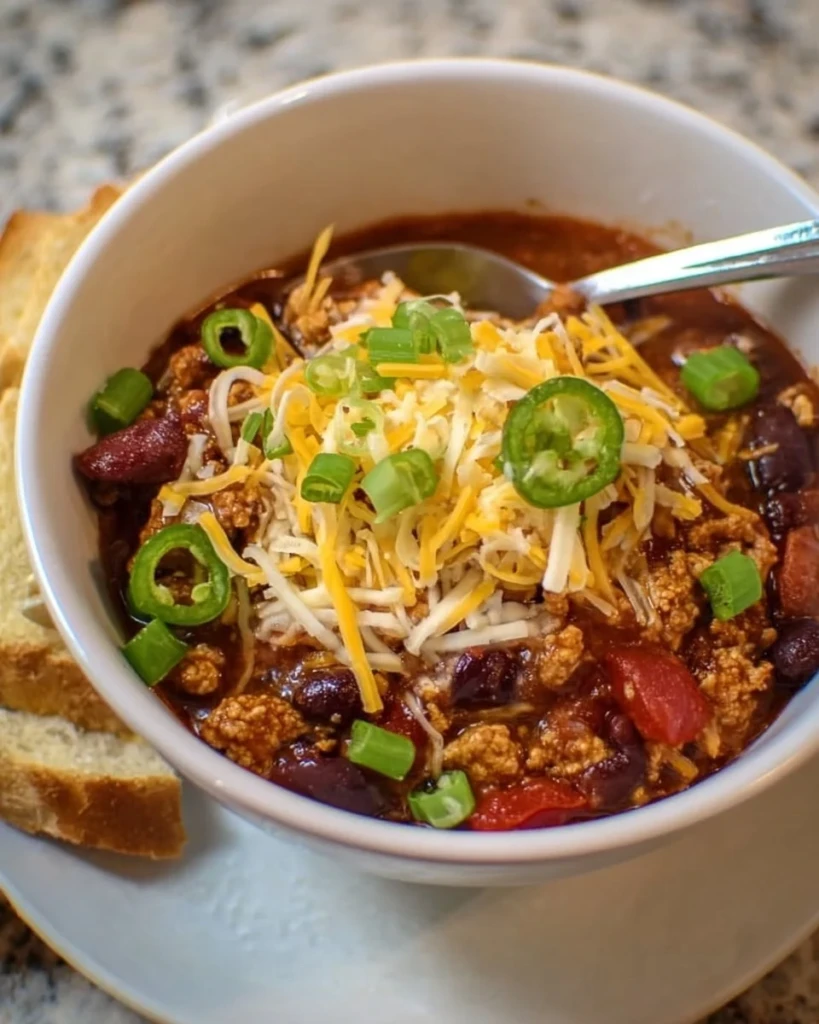 Delicious bowl of ground chicken chili topped with fresh herbs.