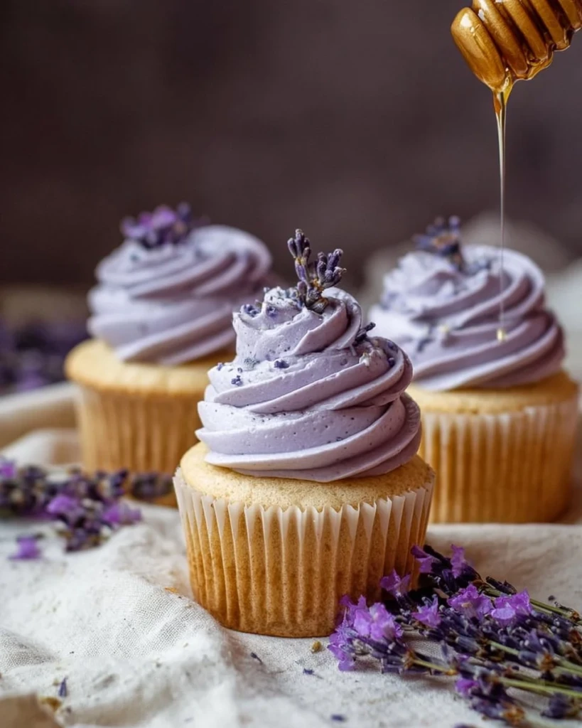 Delicious lavender cupcakes with floral frosting and edible decorations