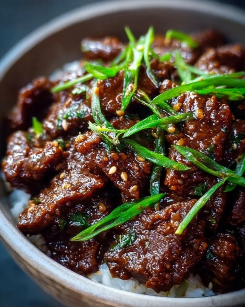 Delicious slow cooker Mongolian beef served with rice and vegetables