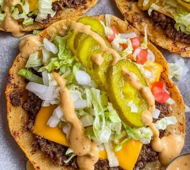 Smash burger tacos featuring juicy beef patties and fresh toppings.